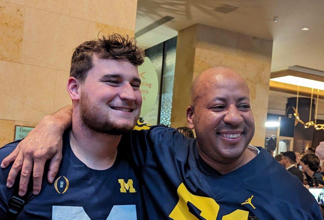 Coach Acosta celebrating with Michigan player