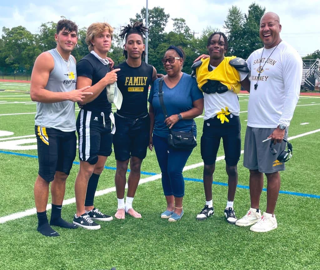 Coach Acosta with players and family