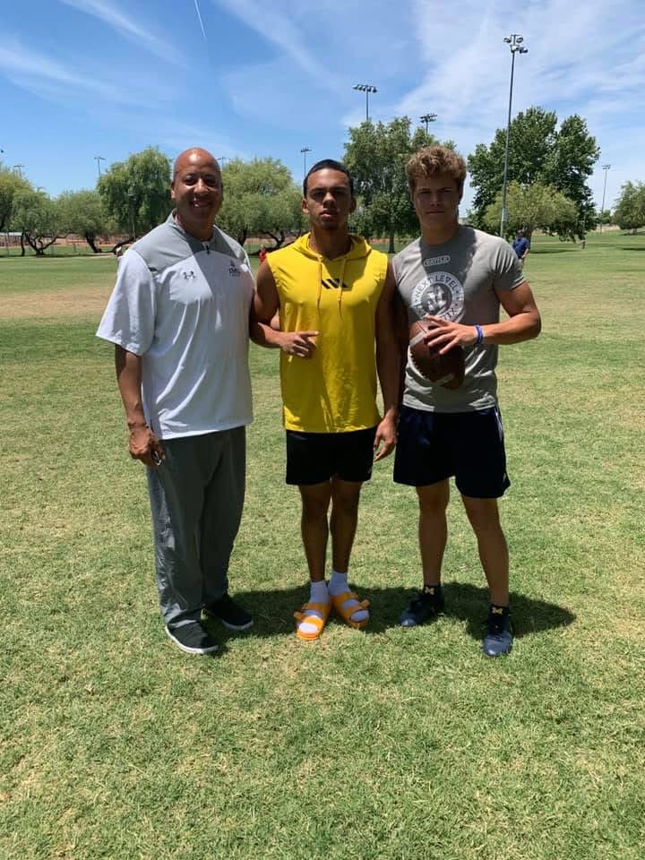 Coach Acosta with two athletes at 7-on-7
